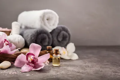 towels, flowers, and a small bottle of oil